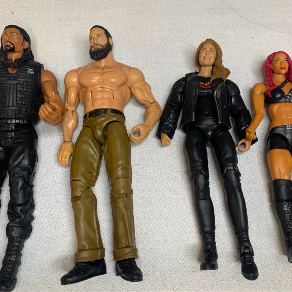 WWE Wrestling Figures Collectibles Roman Reigns Seth Rollins Ronda Rousey…